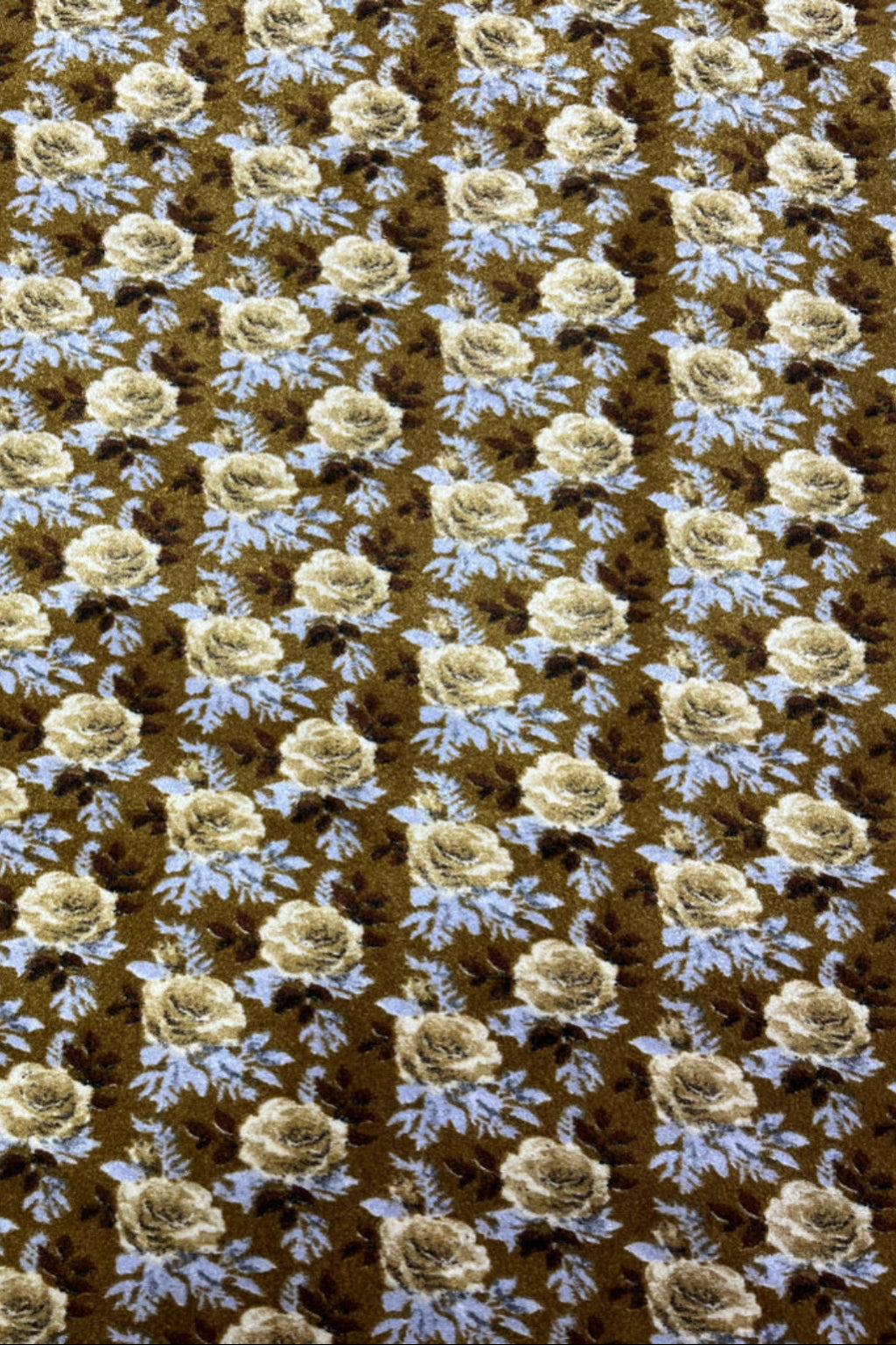 Floral patterned velvet fabric with beige flowers and blue leaves