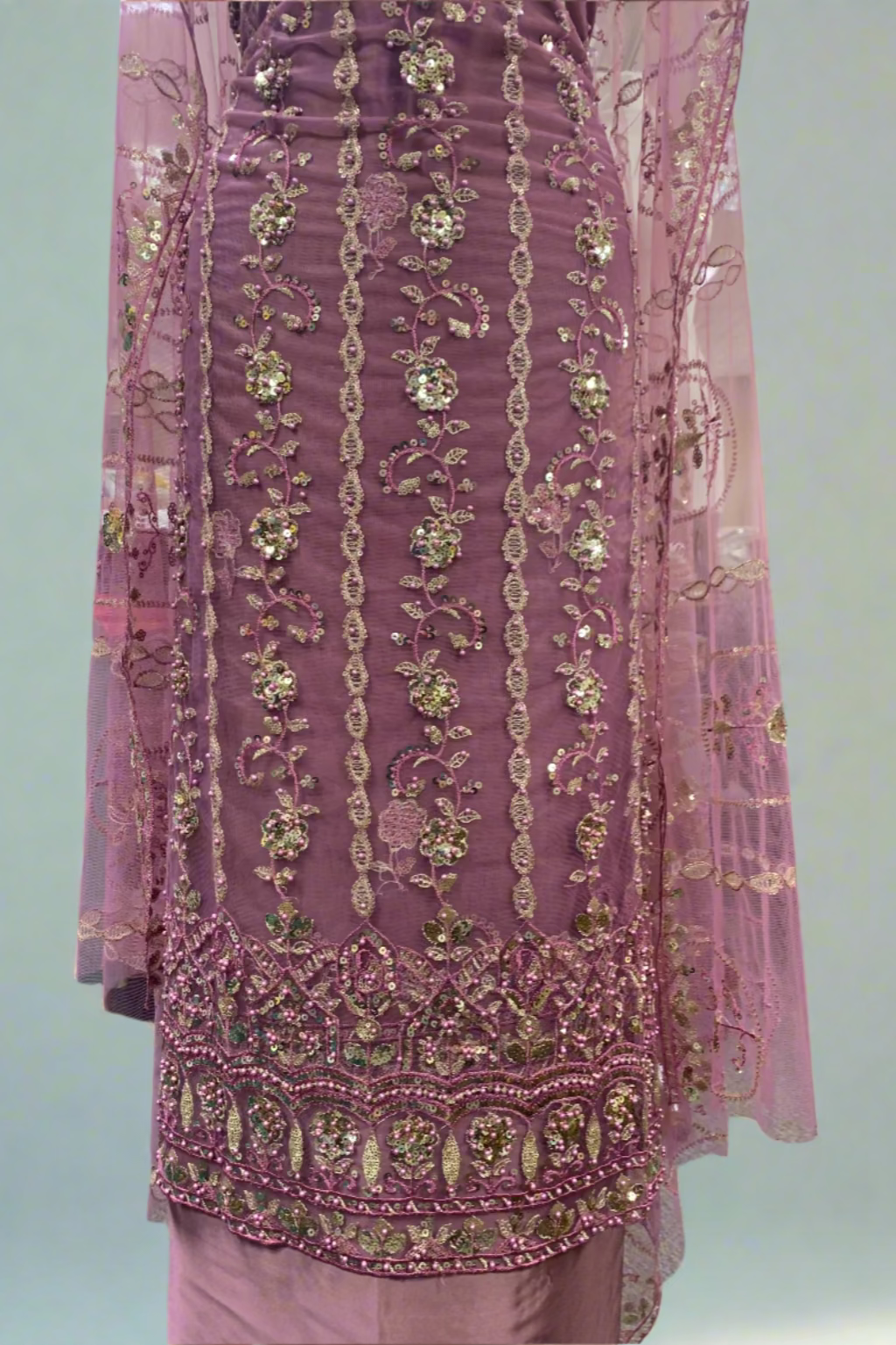 Pink embroidered fabric in a store setting