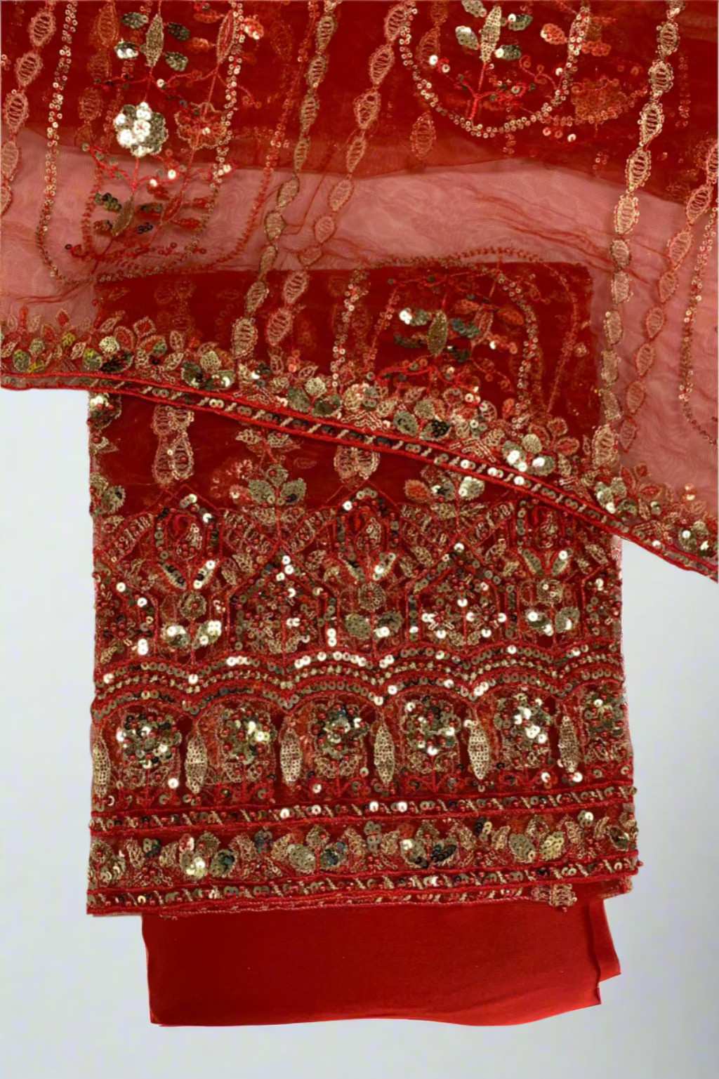 Red fabric with gold embroidery on a white background