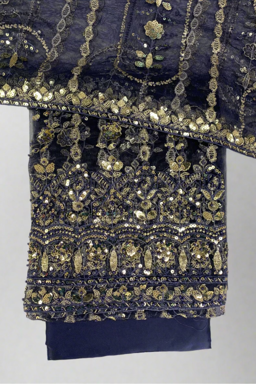 Navy blue fabric with gold embroidery on a white background