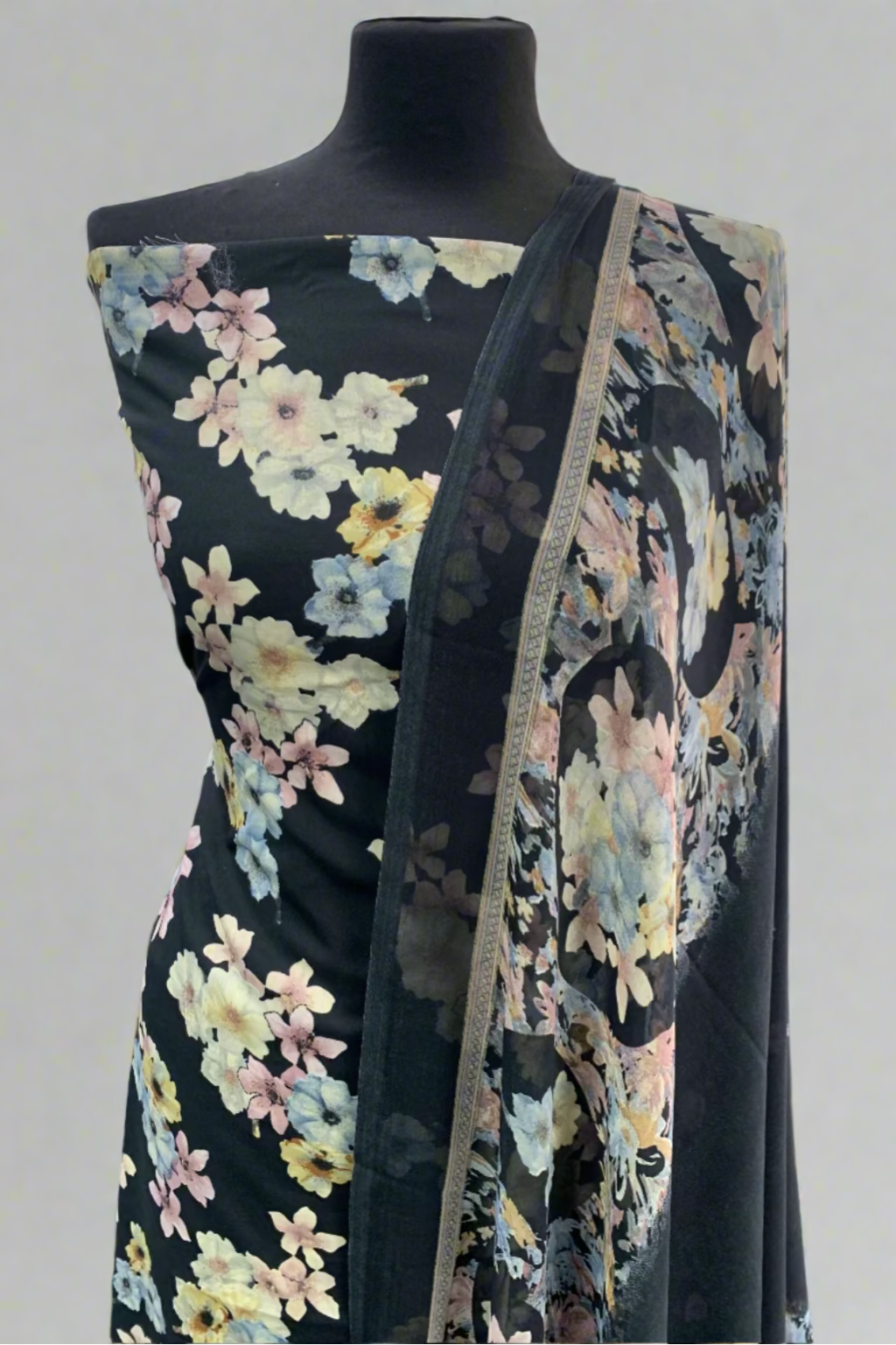 Black floral dress on a mannequin in a fabric store.
