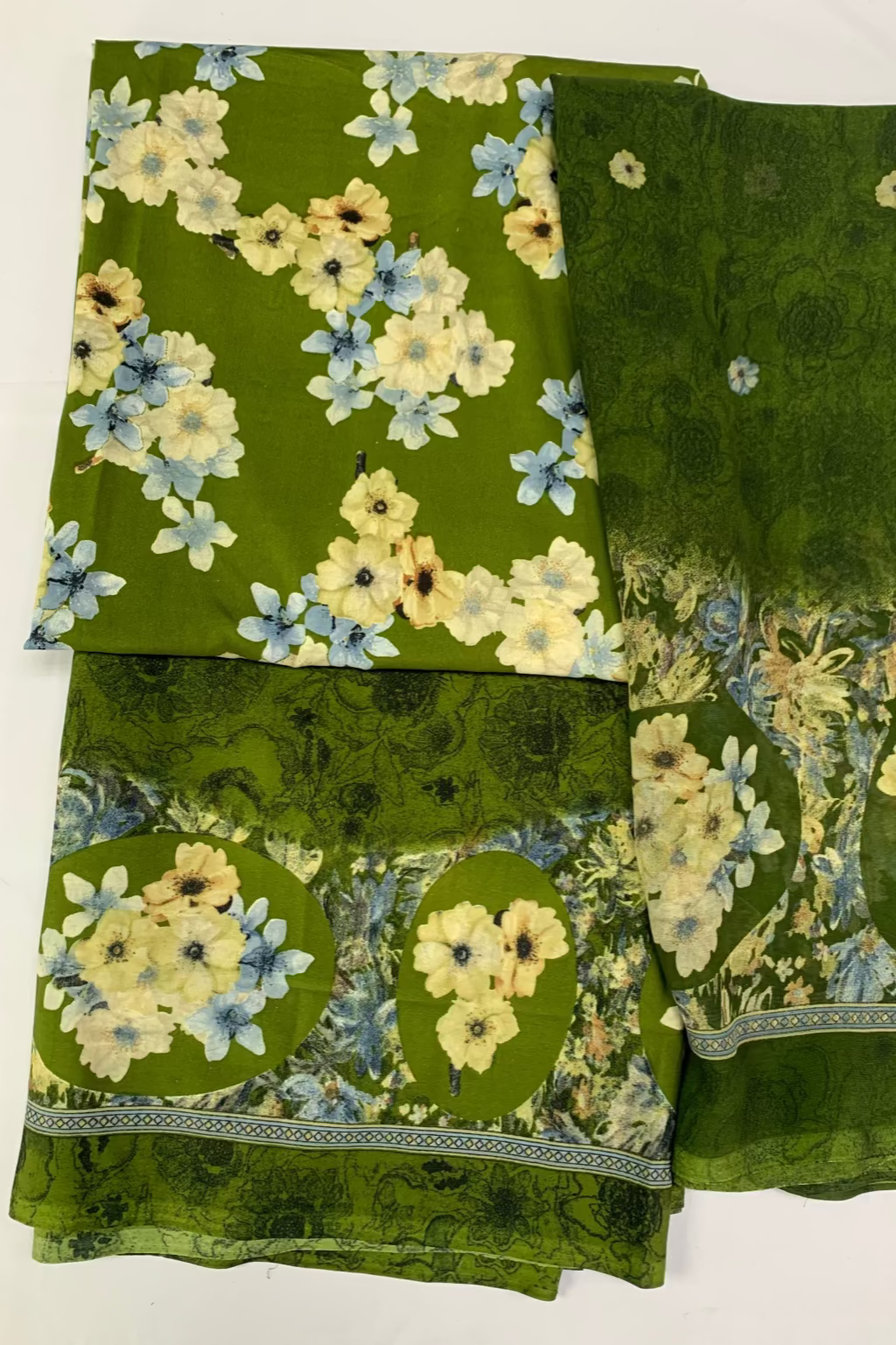 Green fabric with floral pattern on a white background