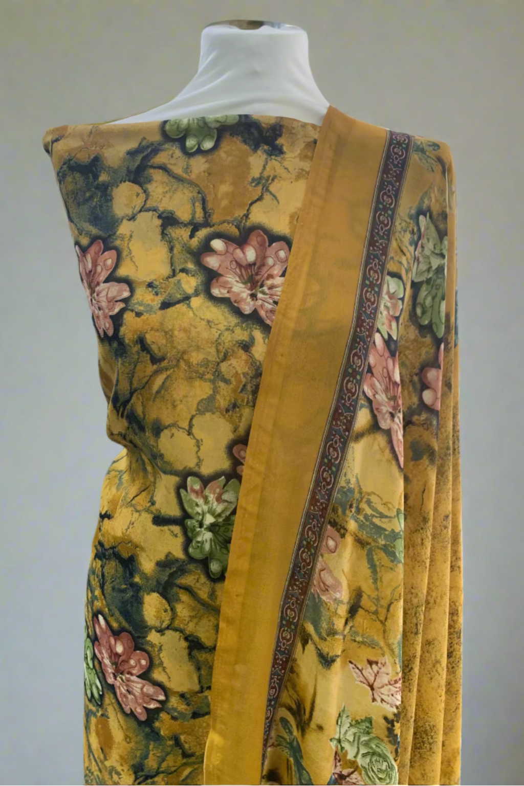 Gold floral patterned fabric on a mannequin in a store setting