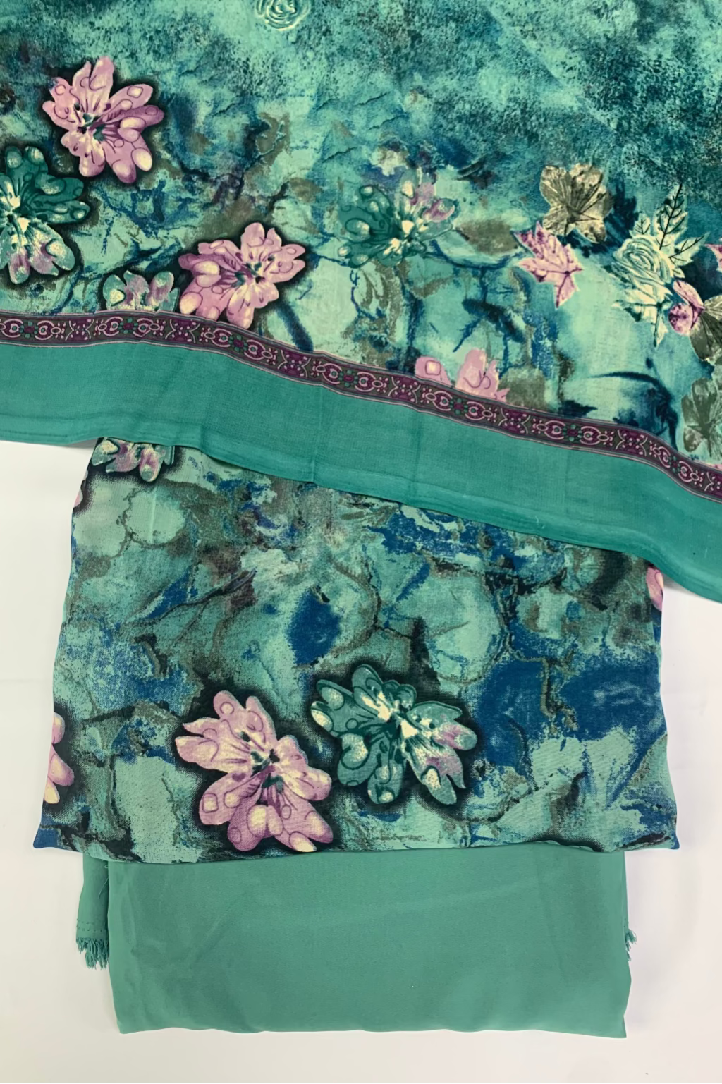 Green fabric with floral print on a white background