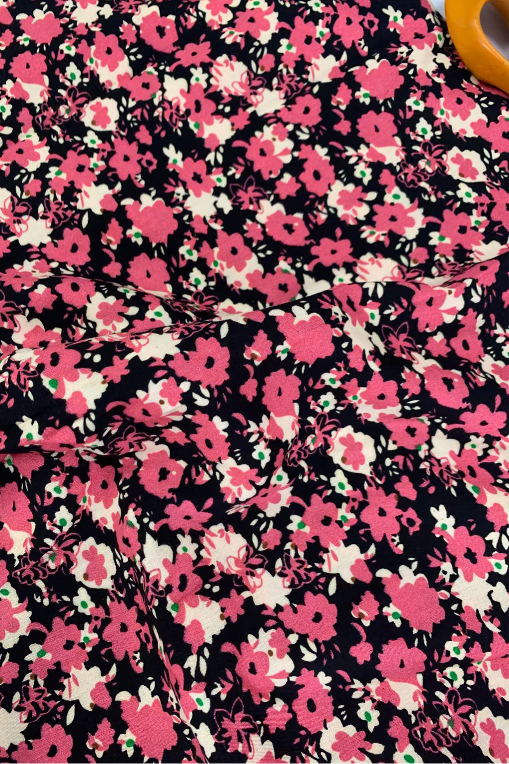 Floral fabric pattern with pink flowers on a black background