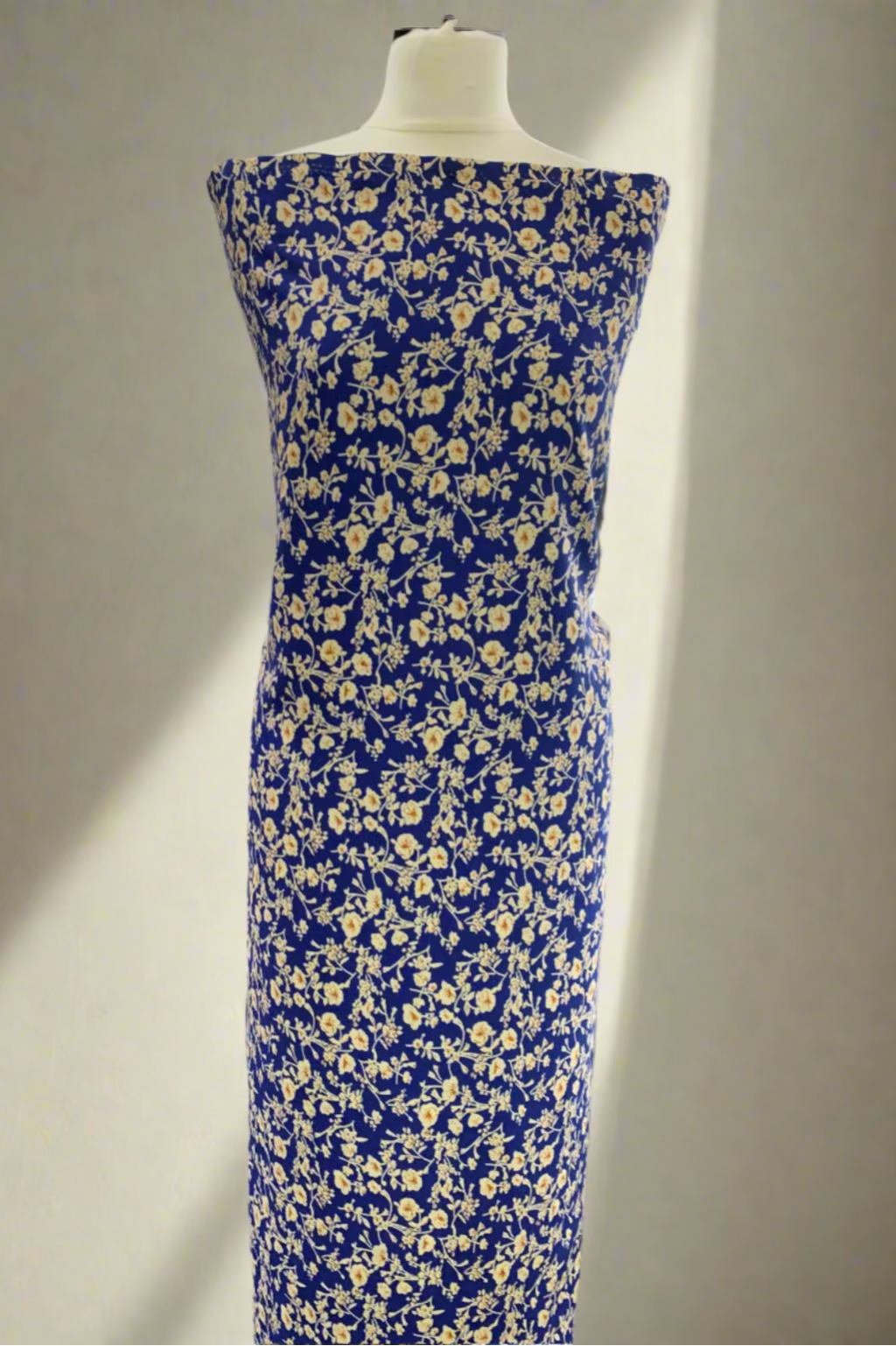 Blue floral dress on a mannequin in a fabric store