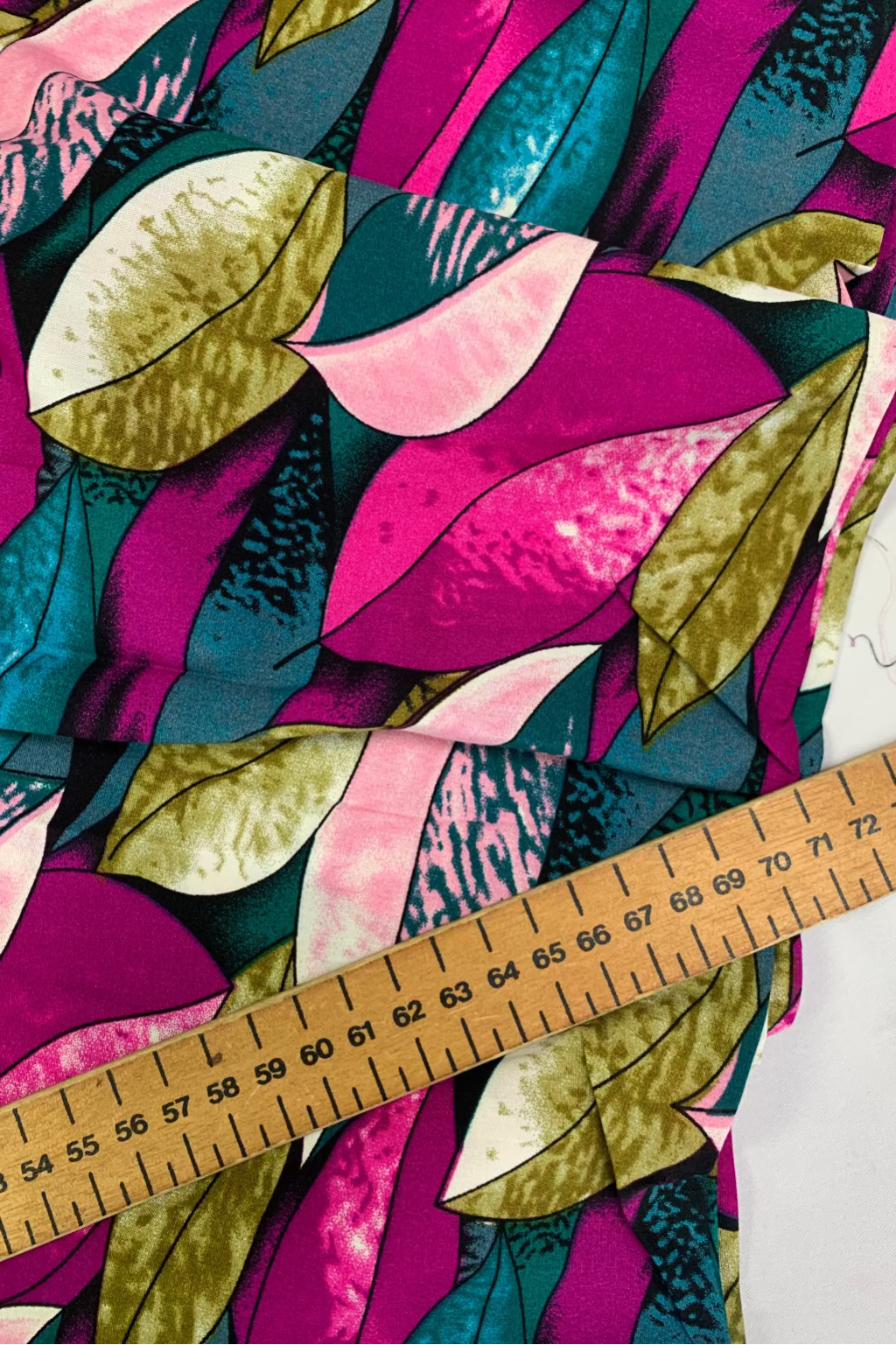 Colorful fabric with leaf pattern and a ruler for scale.