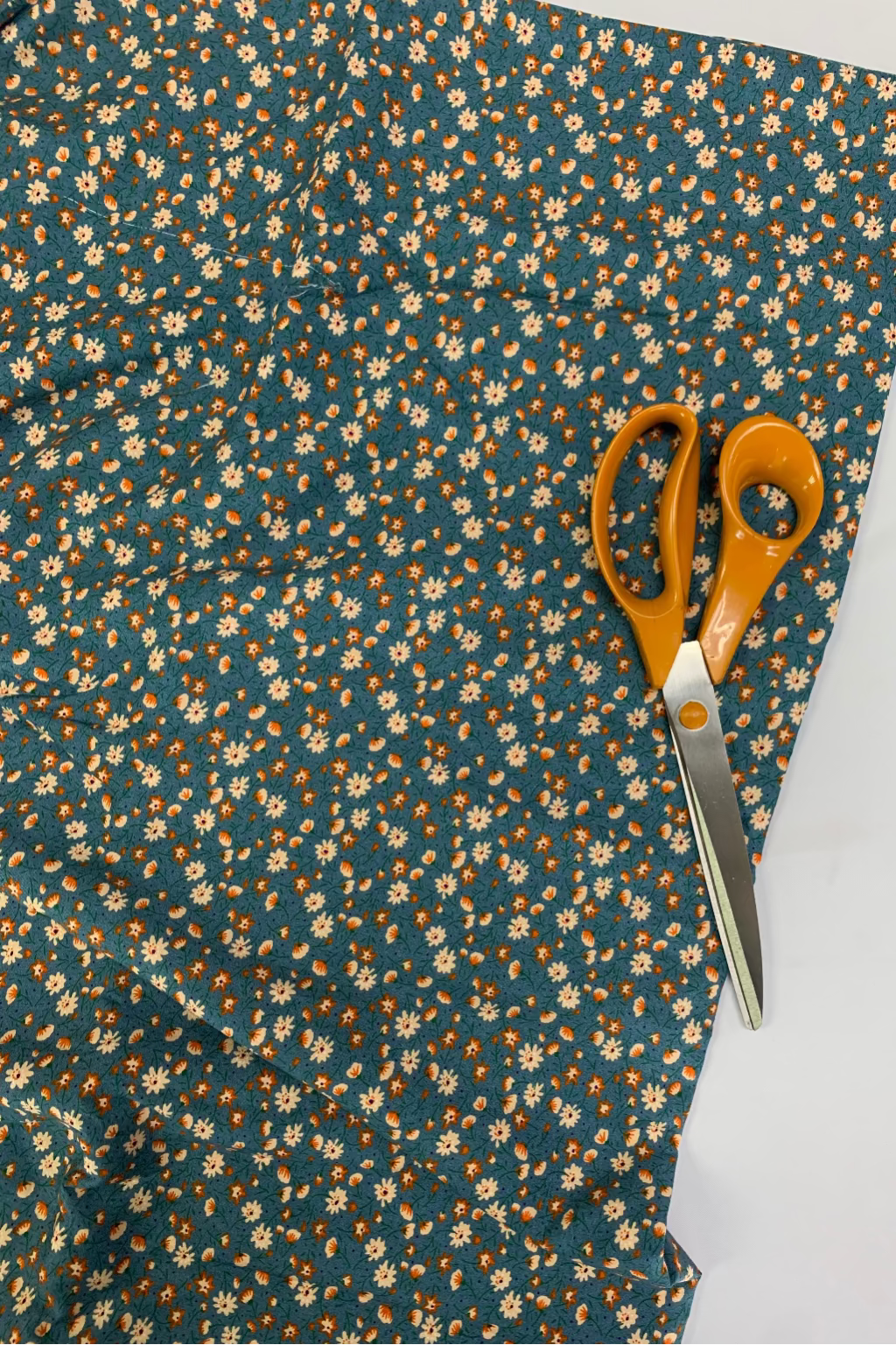 Floral fabric with a pair of scissors on a white background
