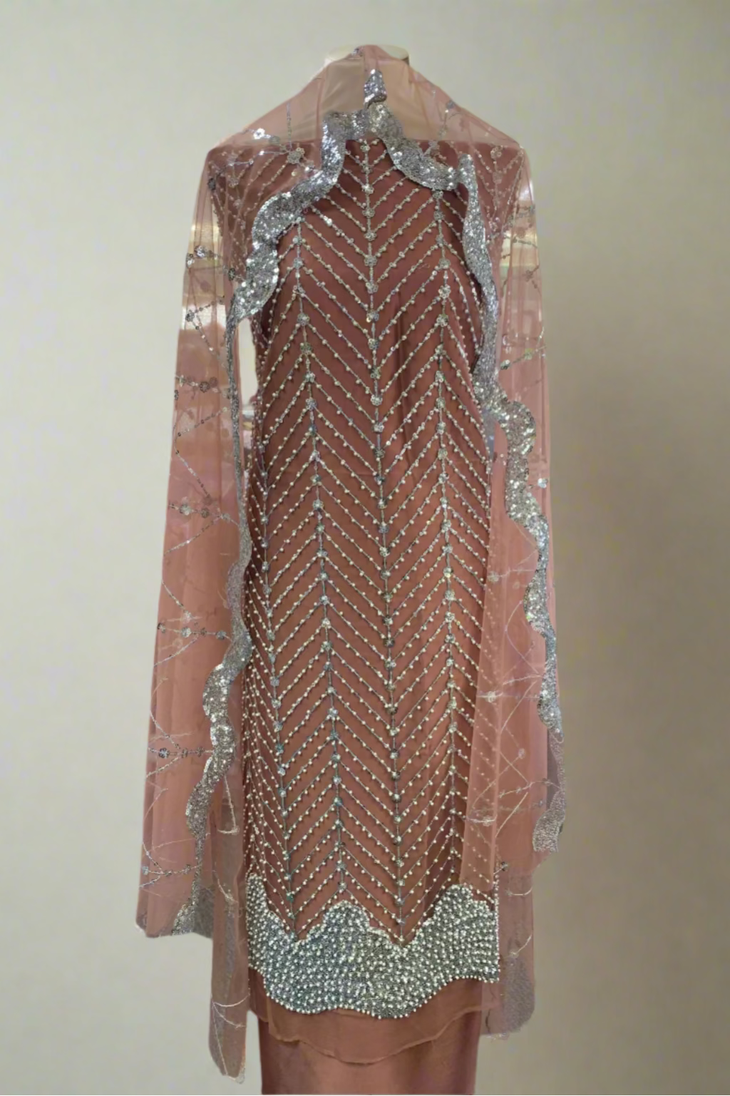 Beaded dress with silver detailing in a store setting