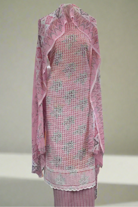 Pink floral dress with matching dupatta on a mannequin in a store setting.