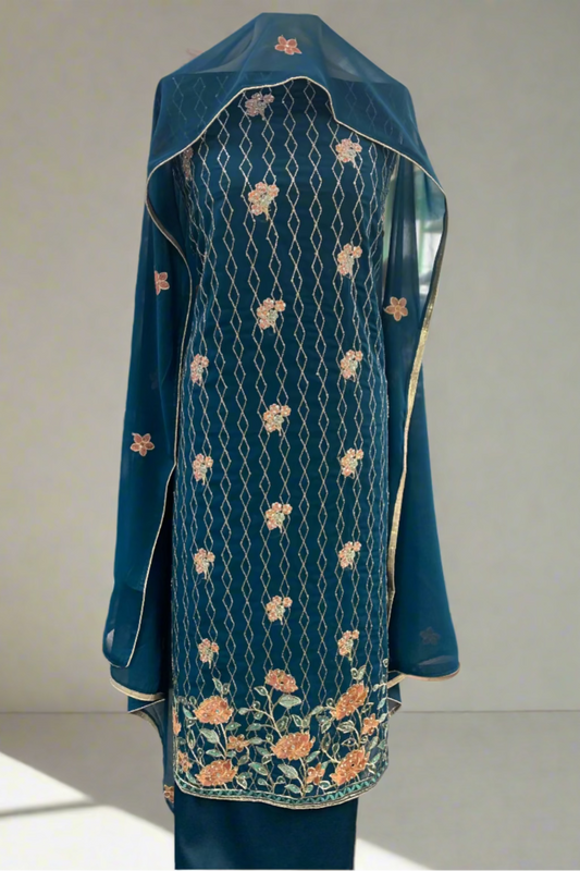 Embroidered blue fabric with floral patterns displayed in a store setting.