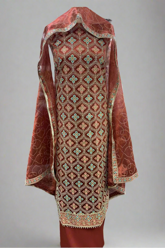 Traditional embroidered garment with a red and gold pattern