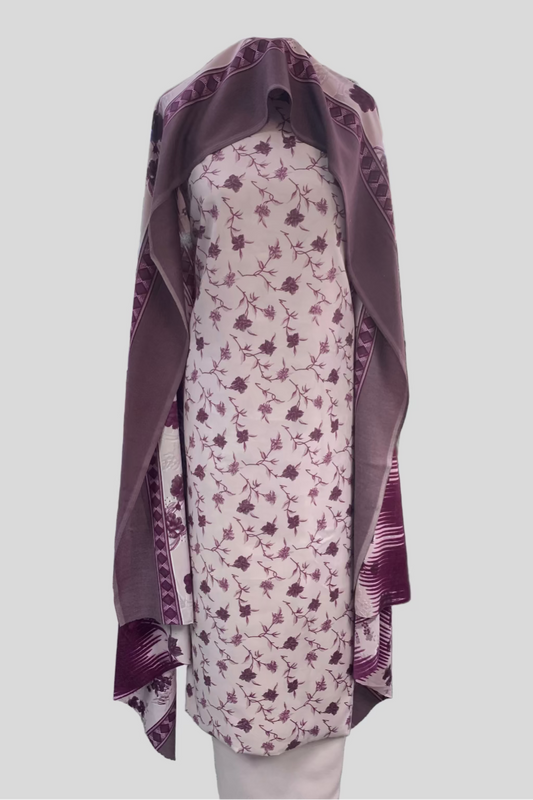 Purple and white floral dress with matching shawl on a mannequin in a store setting.