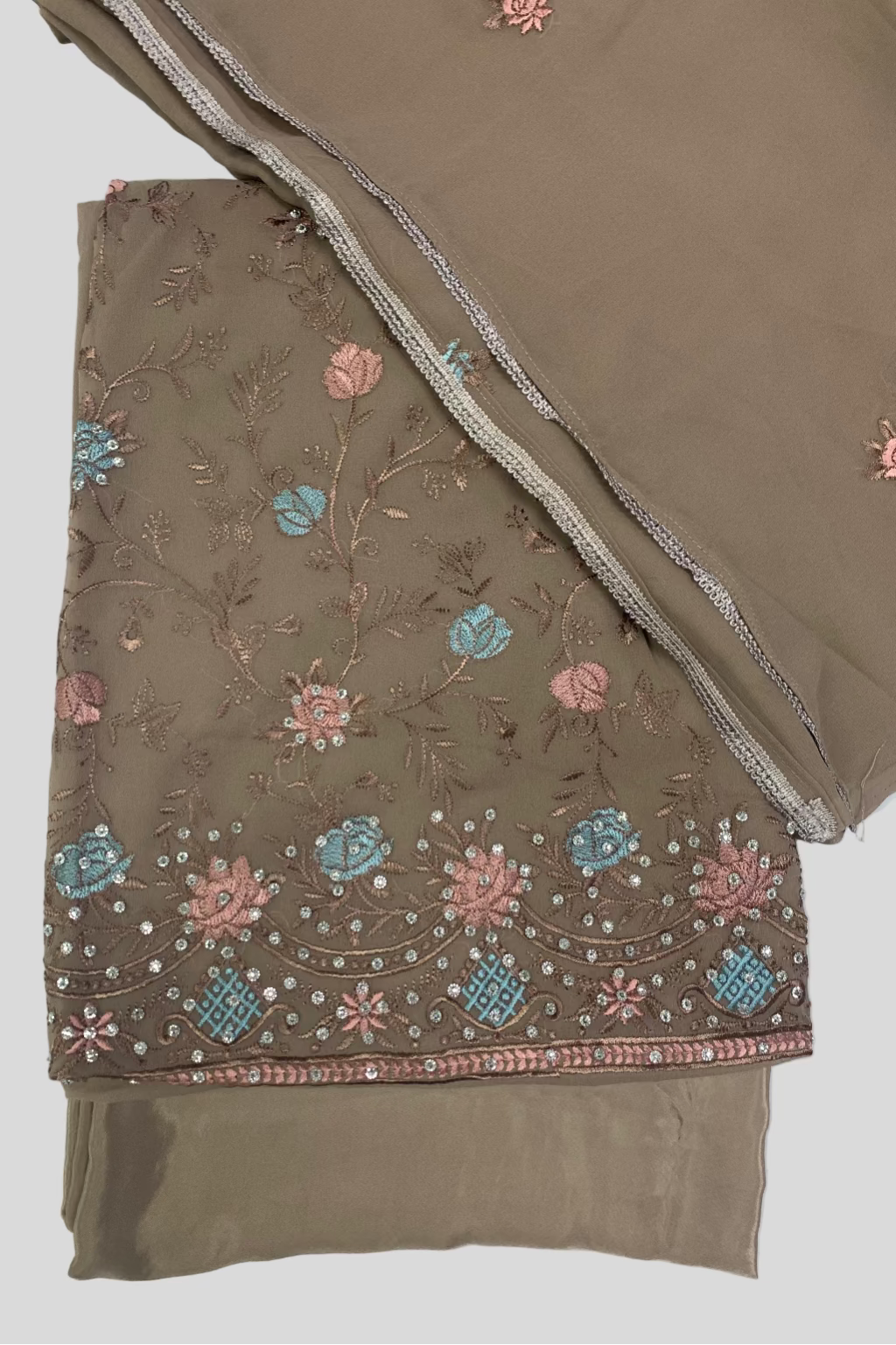 Brown fabric with floral embroidery on a white background