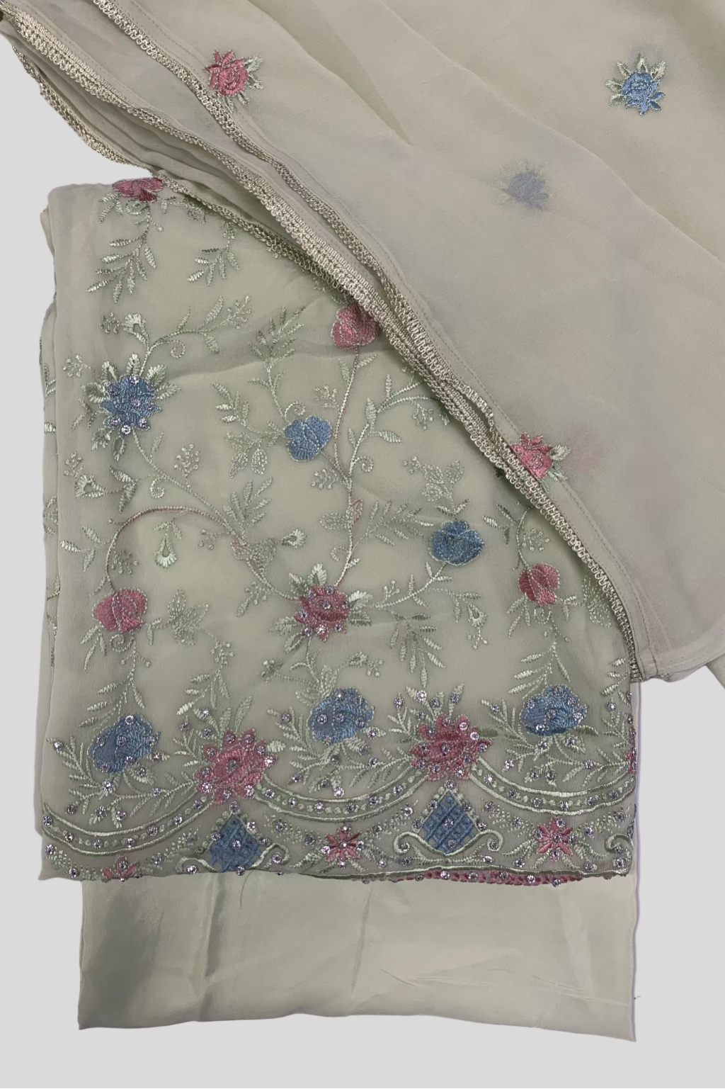 Light green fabric with floral embroidery on a light white background