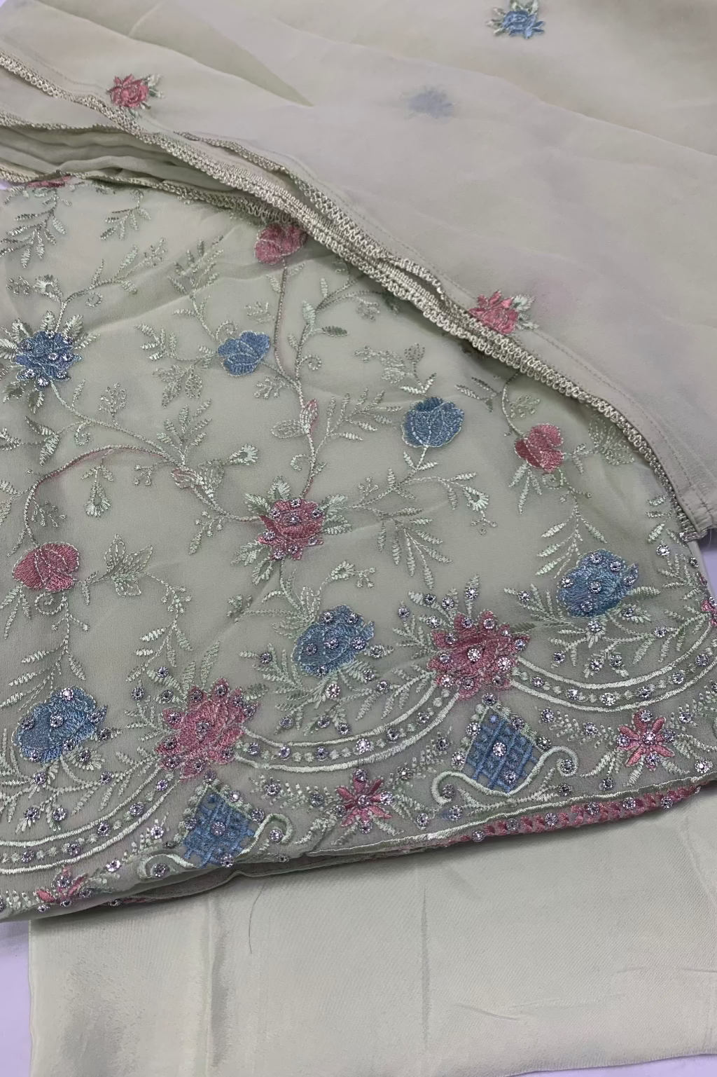 Embroidered fabric with floral patterns on a light background