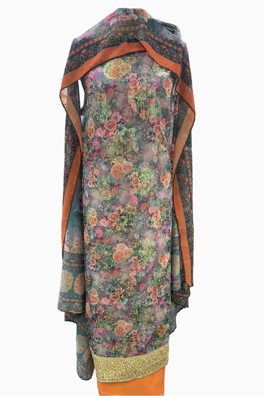 Floral dress with orange accents on a mannequin in a store setting