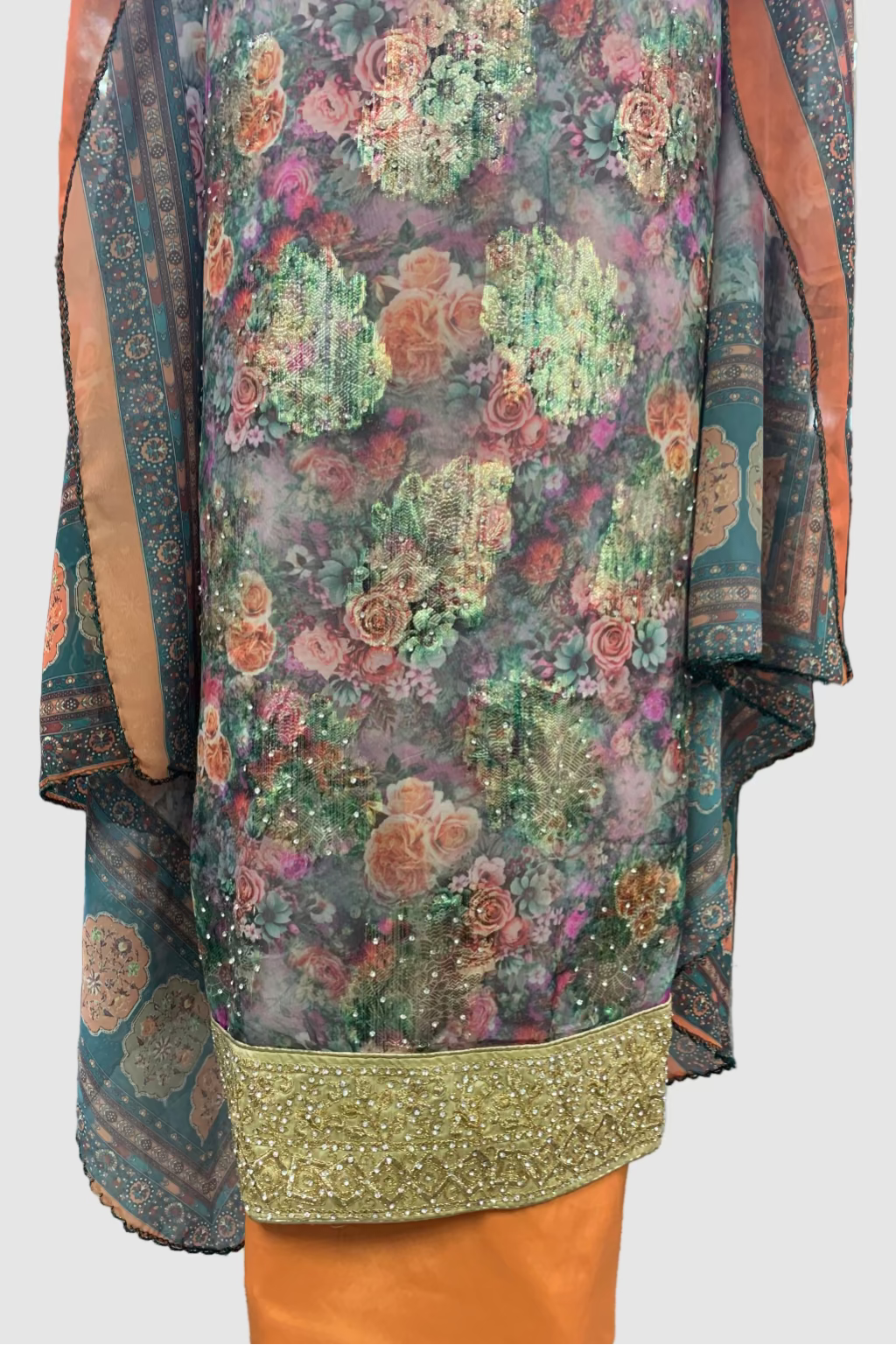 Floral patterned garment with green trim on a store floor