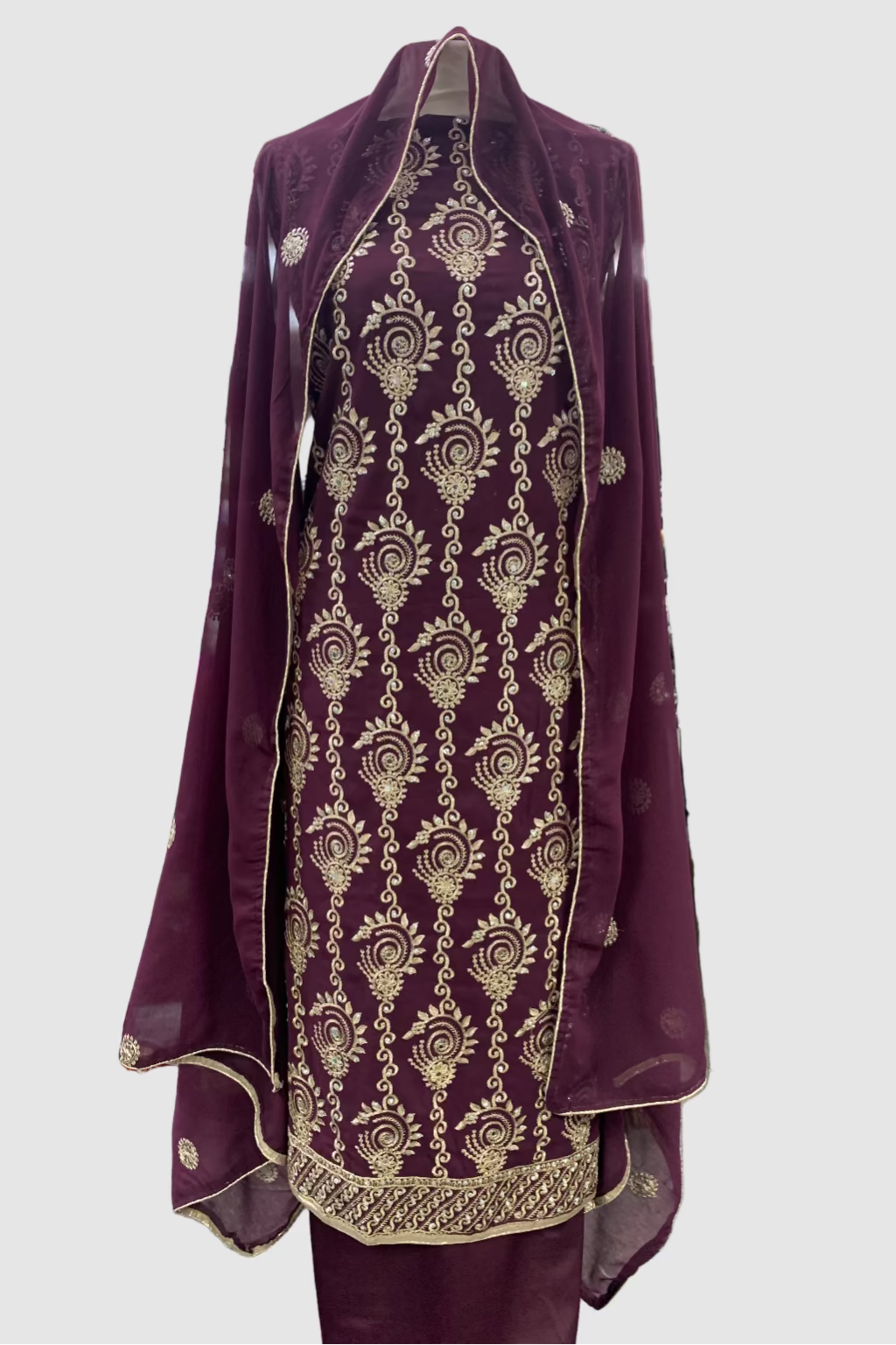 Purple embroidered garment on a hanger in a store setting