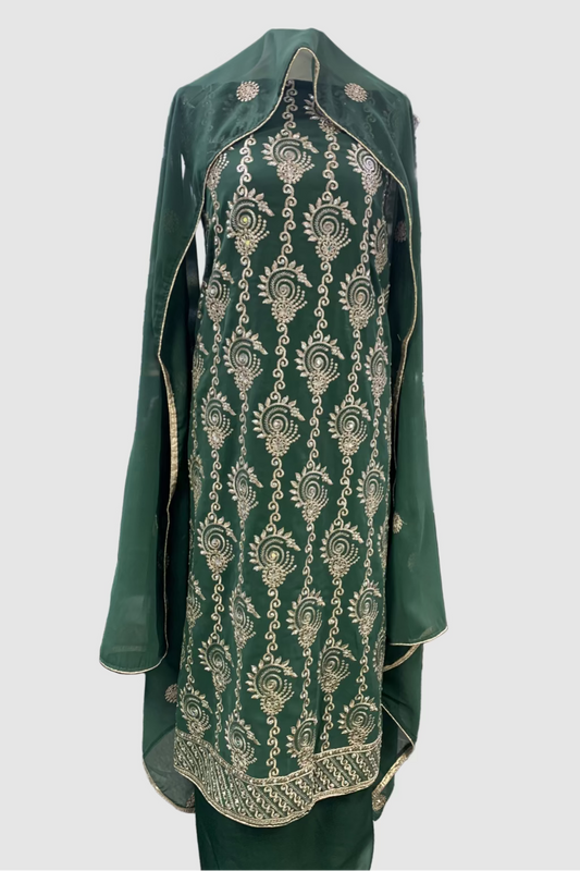 Green embroidered garment on a mannequin in a store setting