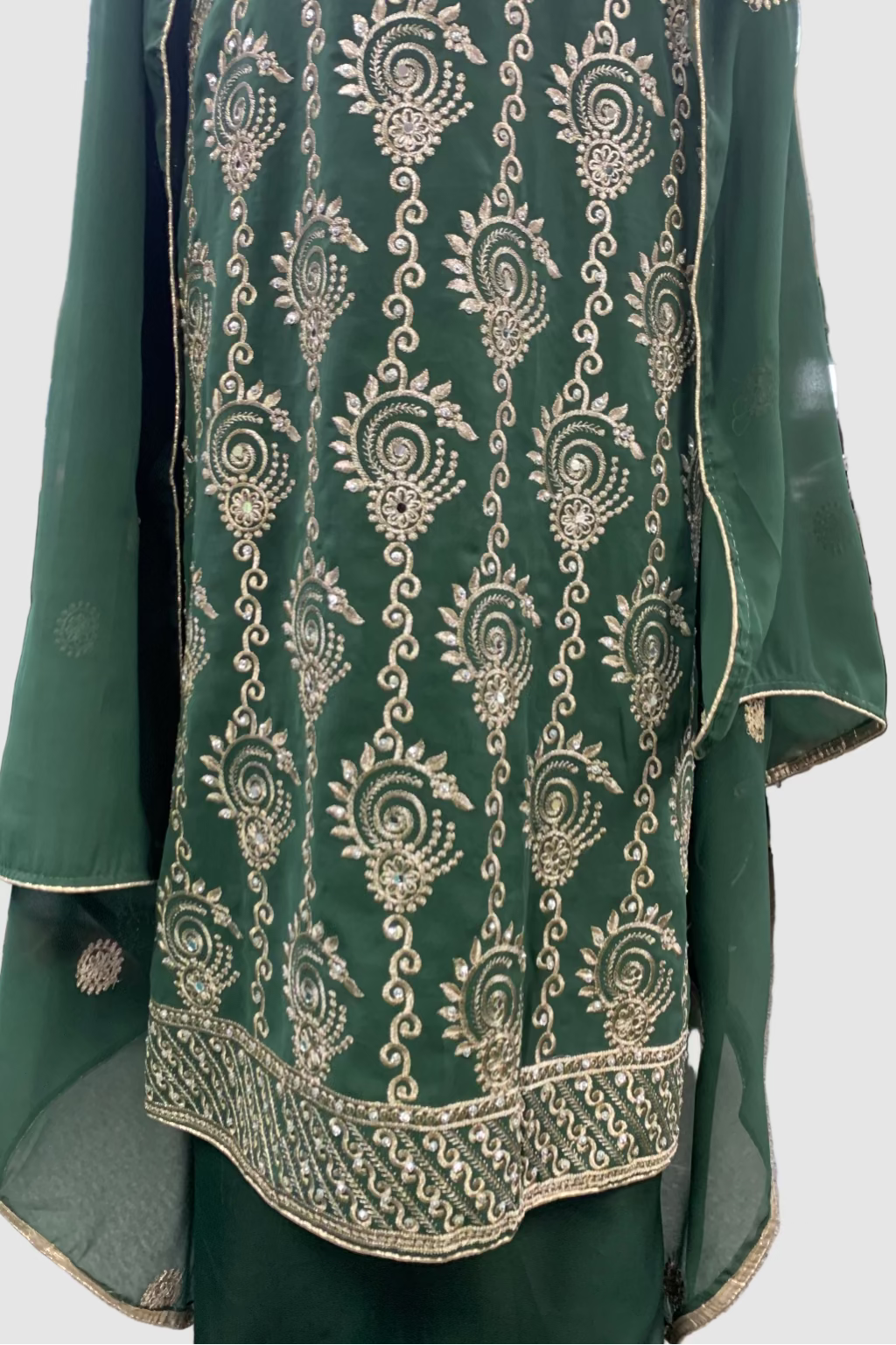 Green embroidered garment in a store setting