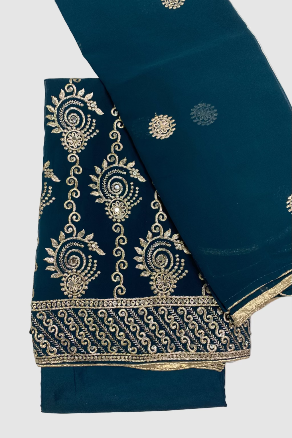 Teal blue fabric with gold embroidery on a white background