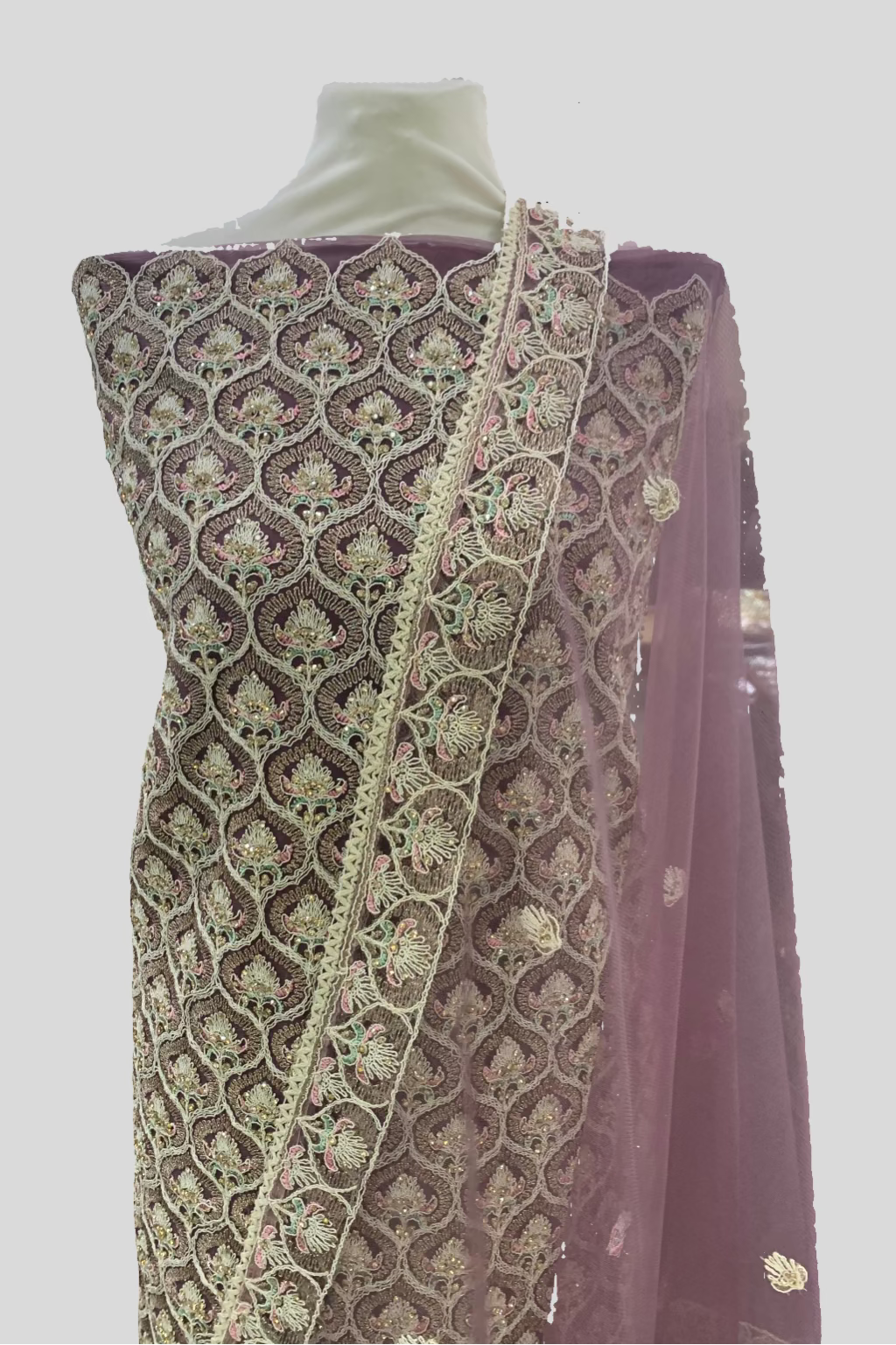 Mannequin wearing a traditional embroidered outfit in a store setting