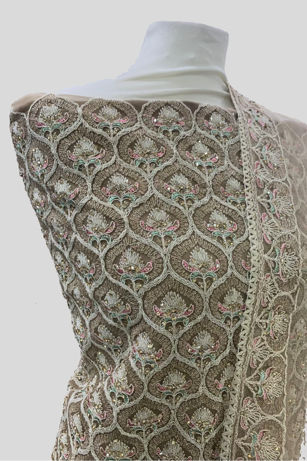 Mannequin wearing a patterned shawl with a blurred indoor background