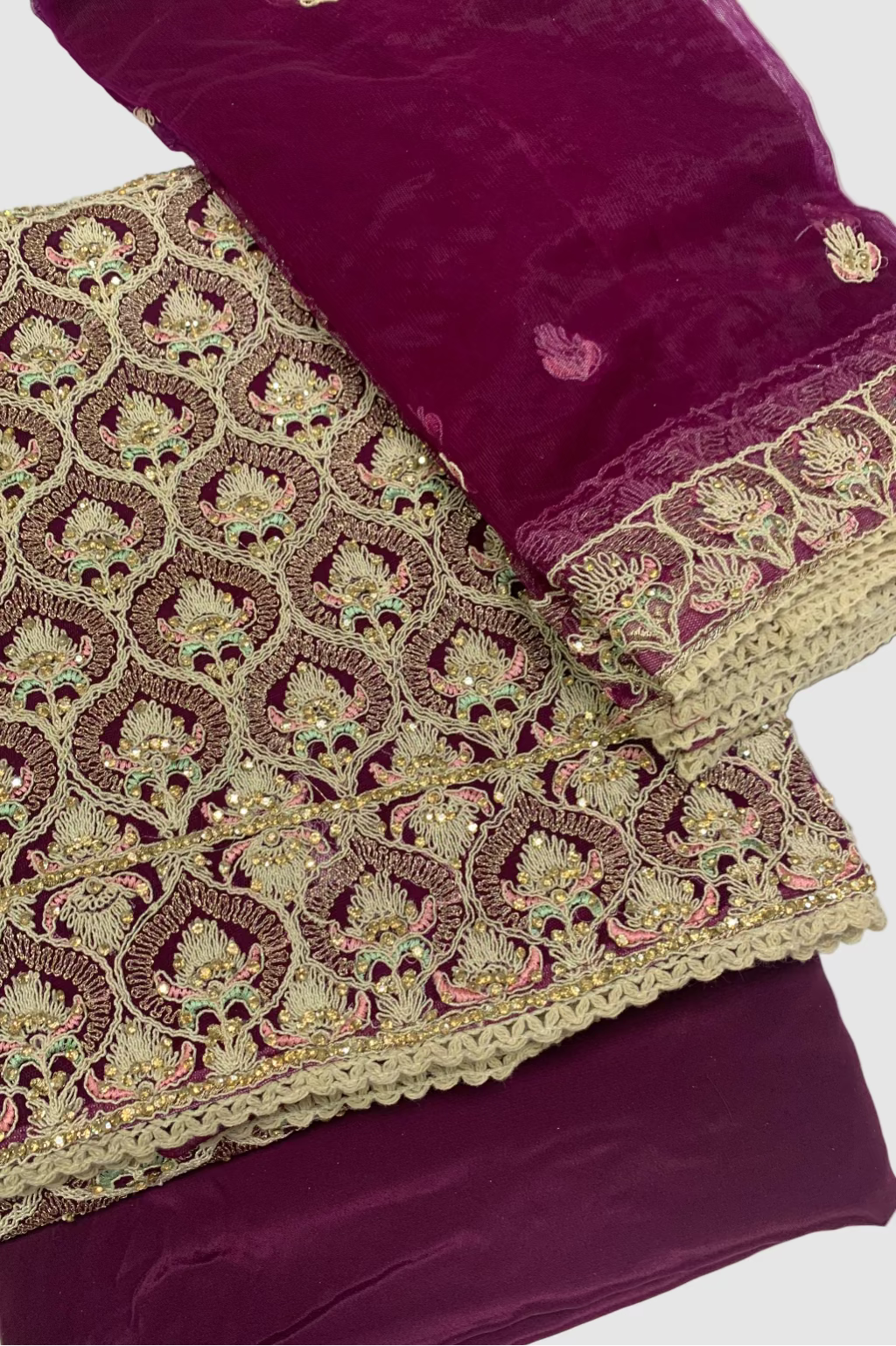 Purple fabric with intricate gold embroidery on a white background