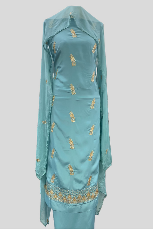 Light blue embroidered traditional outfit in a store setting