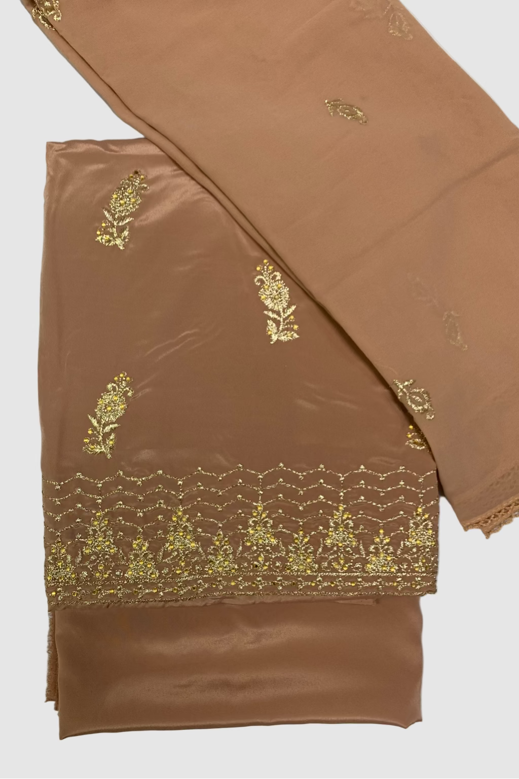Peach fabric with gold embroidery on a white background
