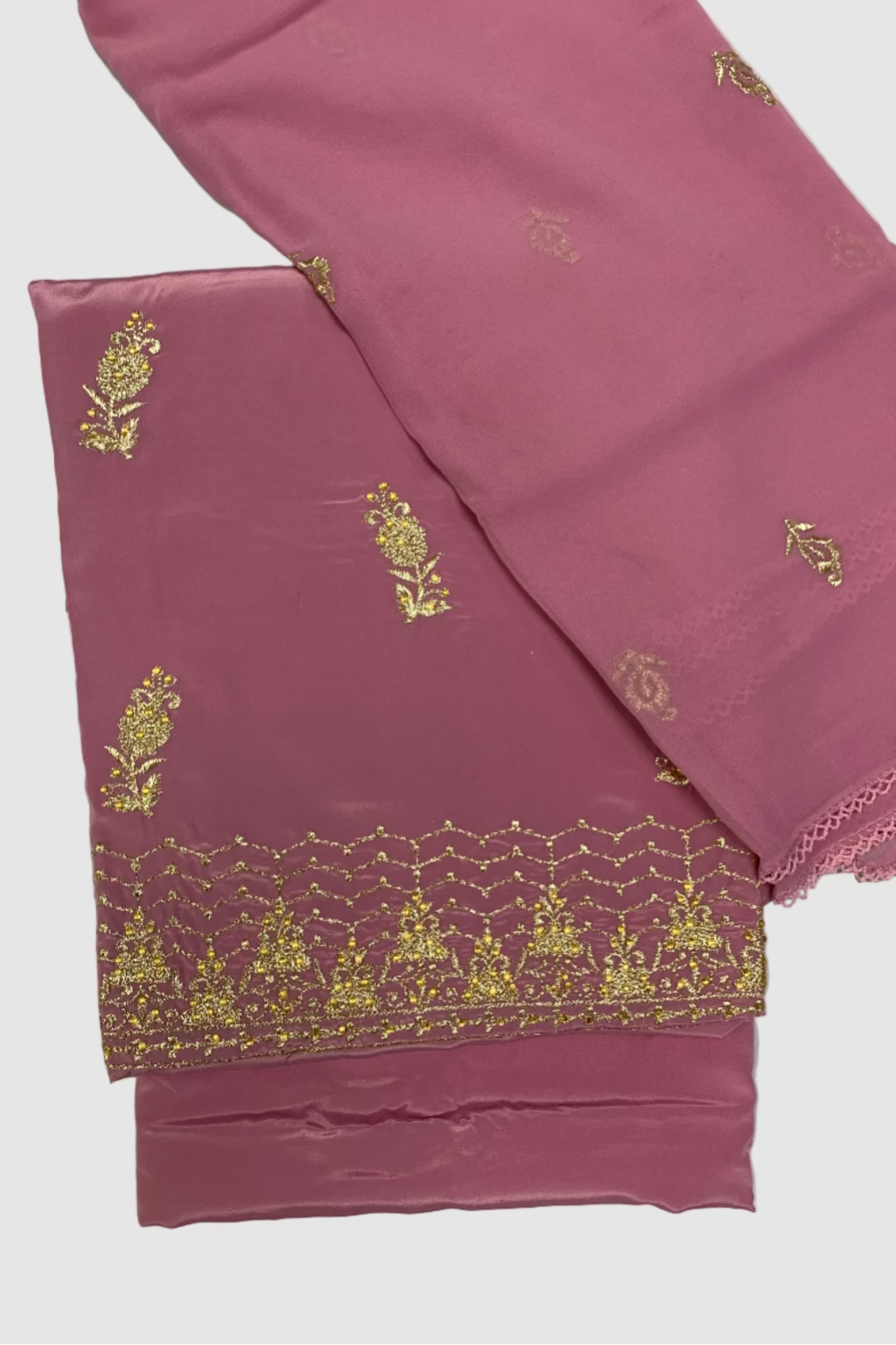 Pink fabric with gold embroidery on a white background