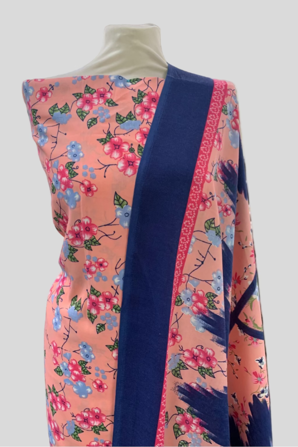 Mannequin wearing a floral-patterned garment in a store setting