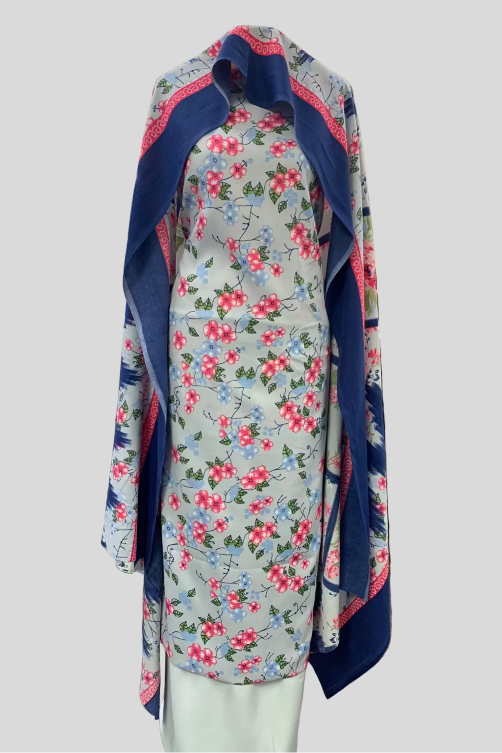 Floral fabric with blue border displayed in a fabric store