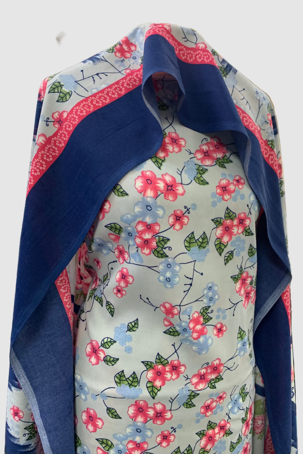 Floral fabric with blue border on a mannequin in a store setting