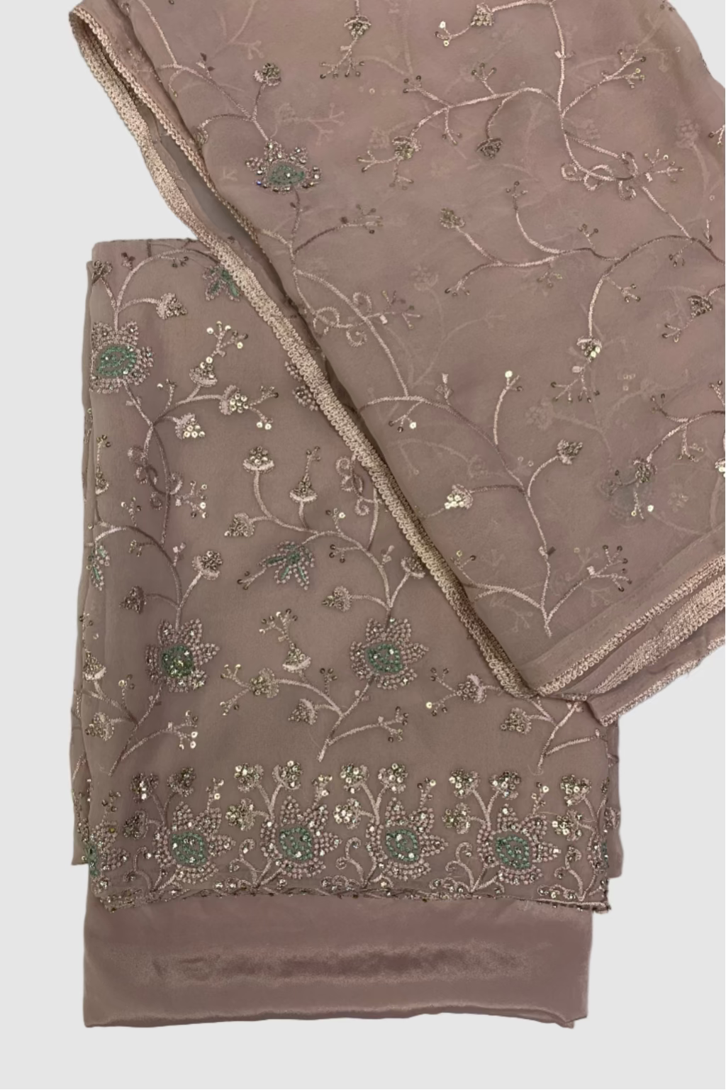Beige fabric with floral embroidery on a light gray background