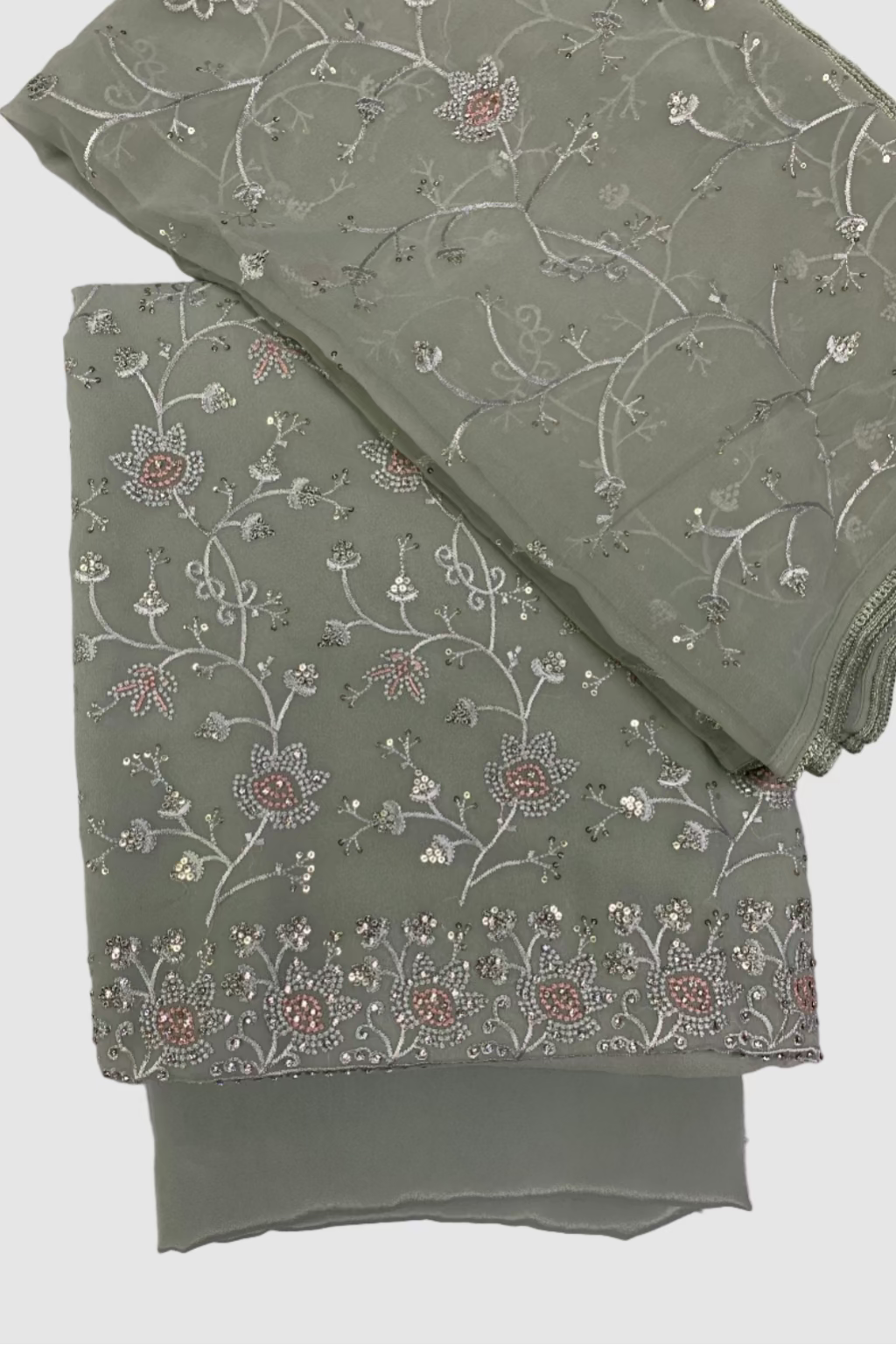 Green fabric with floral embroidery on a white background