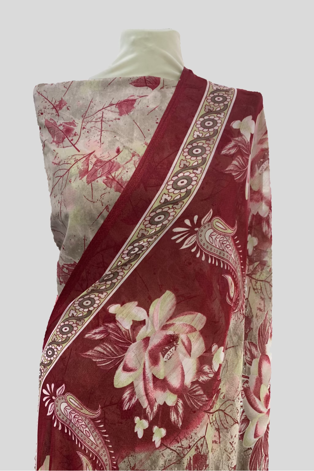 Red and white floral patterned fabric on a mannequin in a store setting