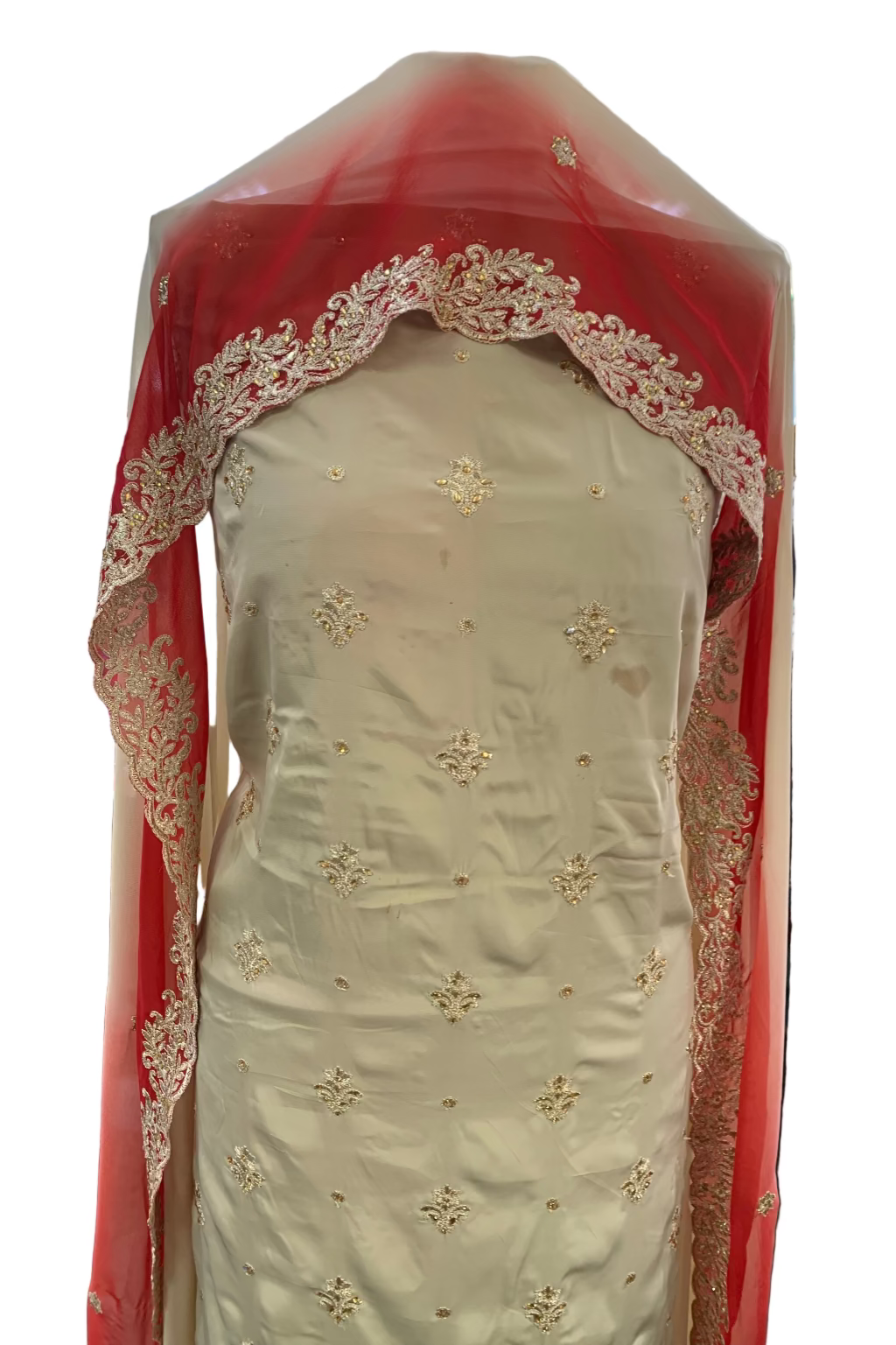 Traditional embroidered garment with red border in a store setting