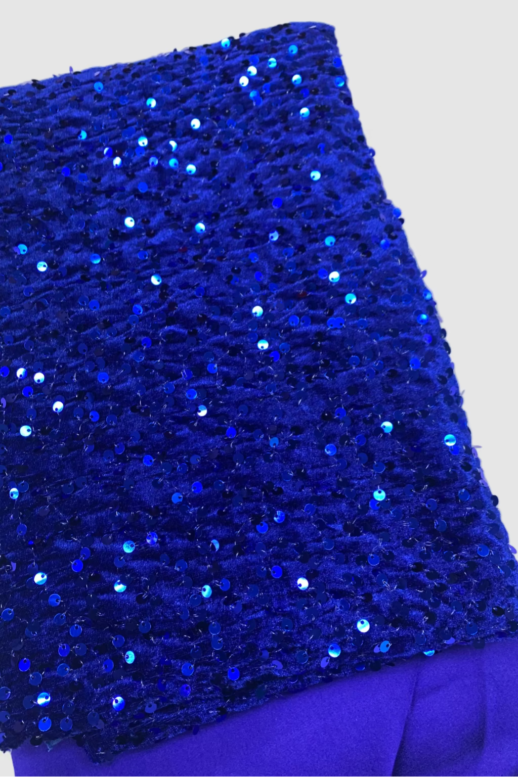 Blue velvet fabric with sequins on a white background