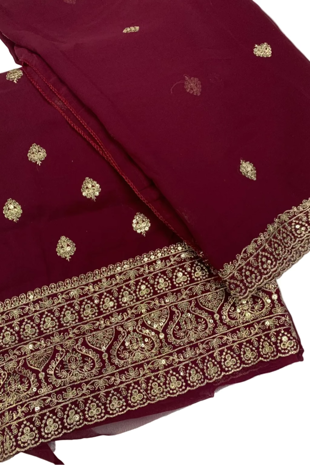 Maroon fabric with gold embroidery on a white background
