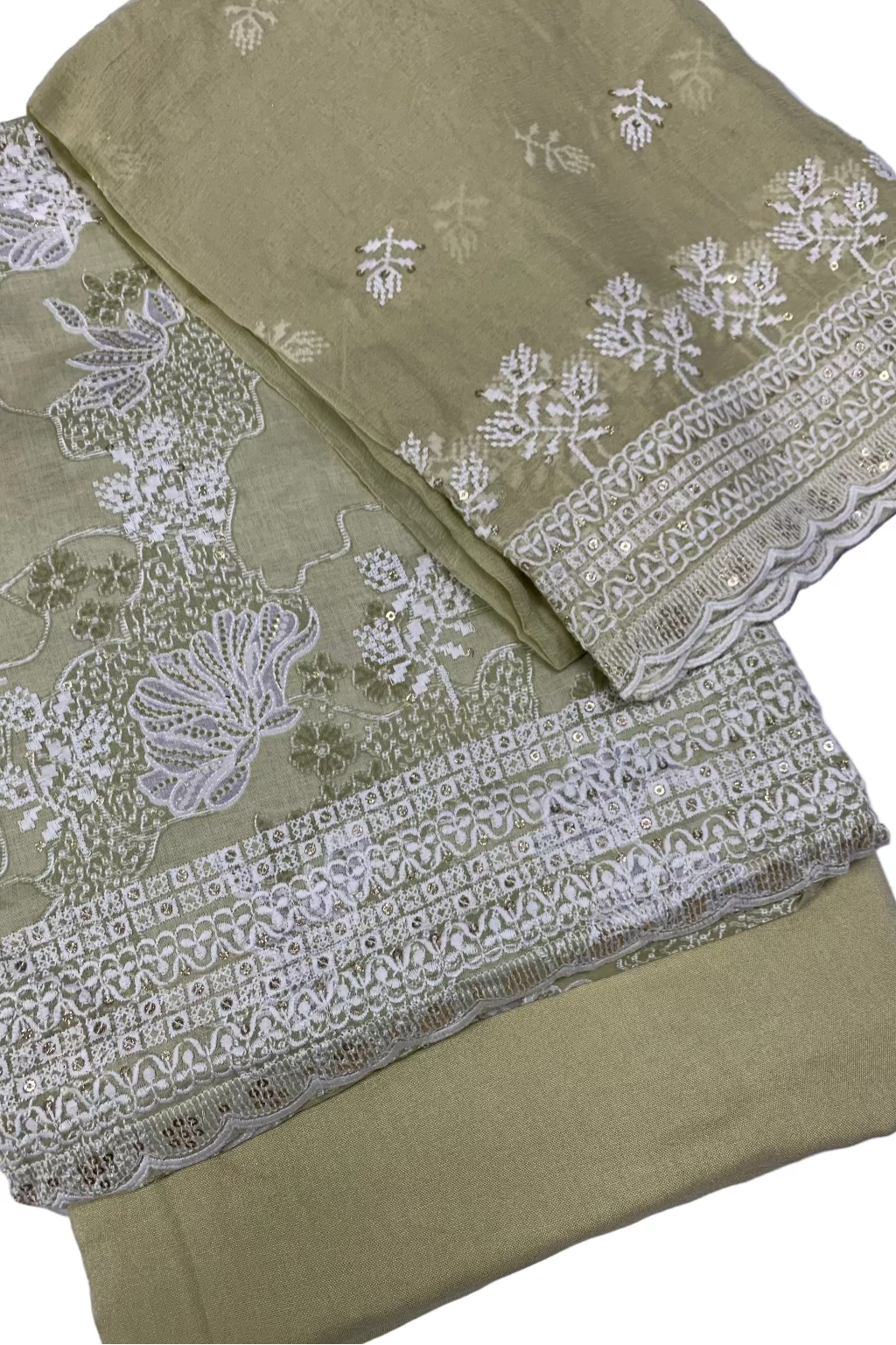 Green fabric with white floral embroidery on a white background