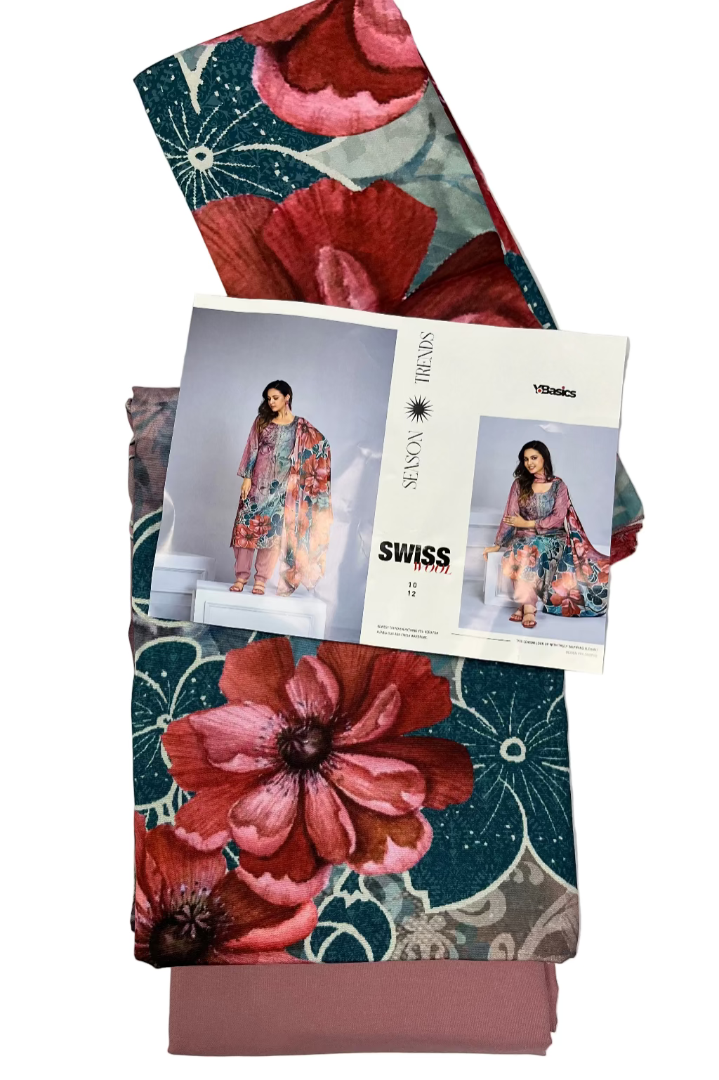 Floral-patterned fabric with a magazine featuring fashion images on top