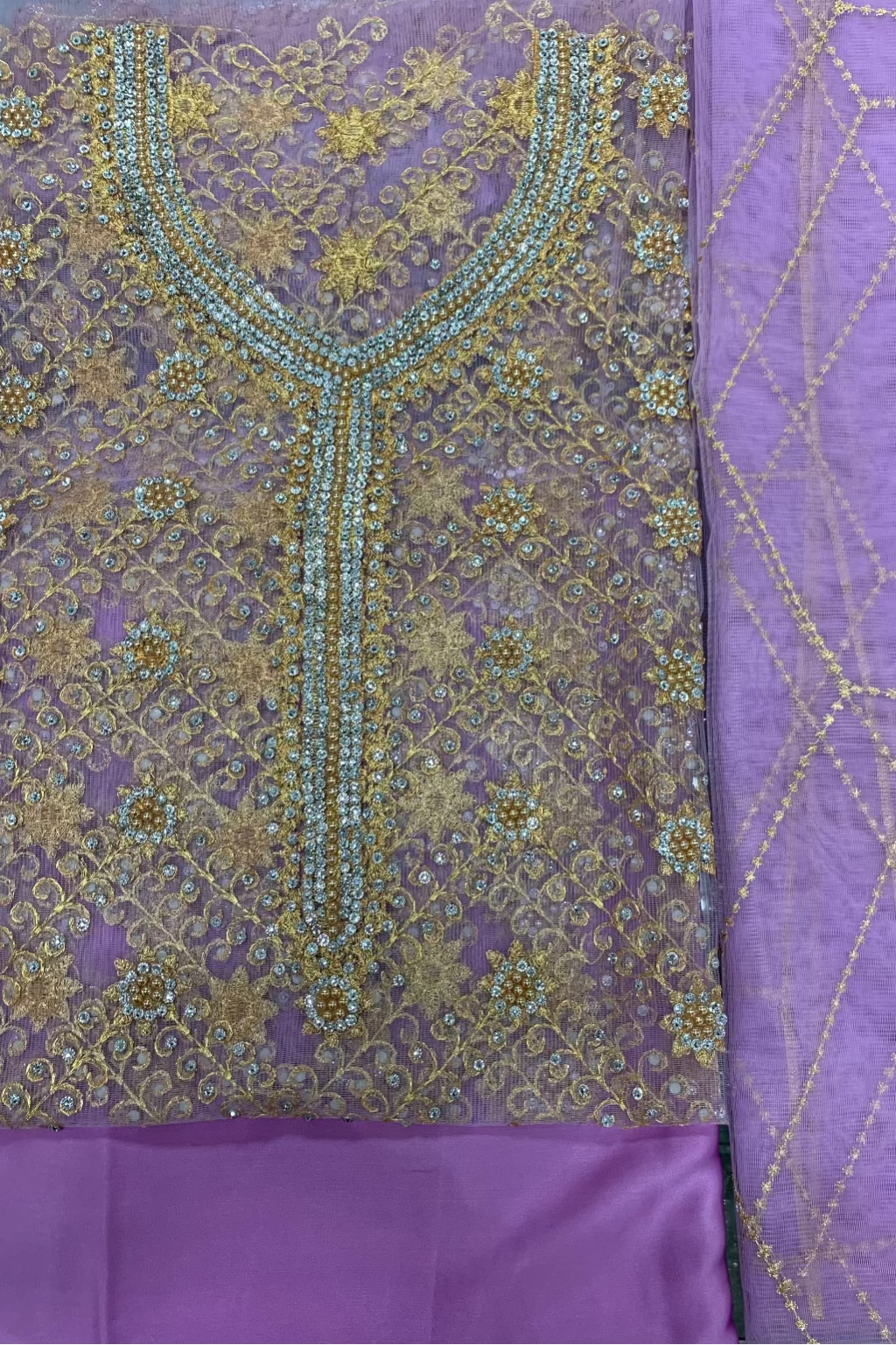 Purple fabric with intricate gold embroidery