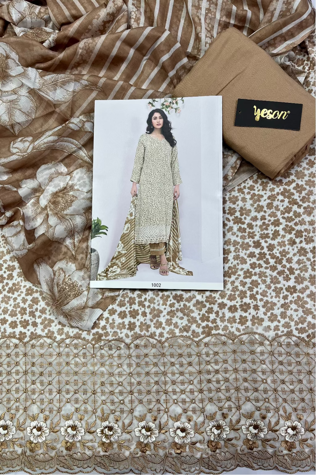 Textile with floral patterns and a model wearing a dress on a white card, with 'yeson' branding.