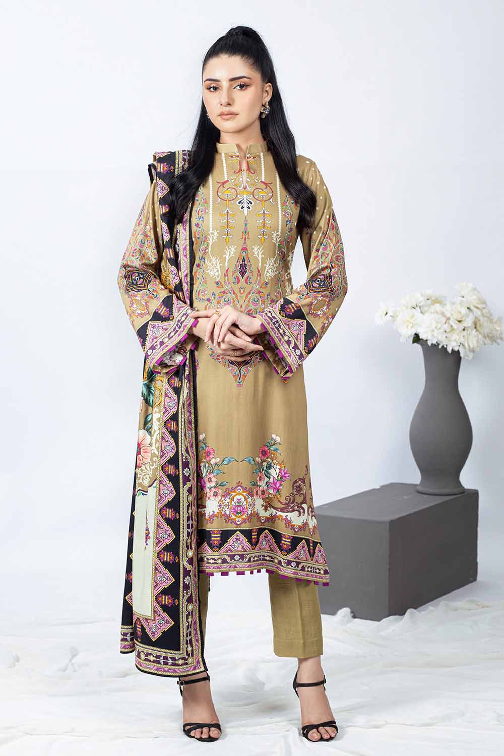 A woman modeling an unstitched printed Cotail Salwar Kameez Suit by Gul Ahmed, consisting of a dupatta, shirt, and trouser.
