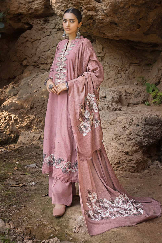 A woman wearing a traditional pink salwar kameez suit with embroidered sequins and floral patterns, part of the Gul Ahmed Winter Collection.