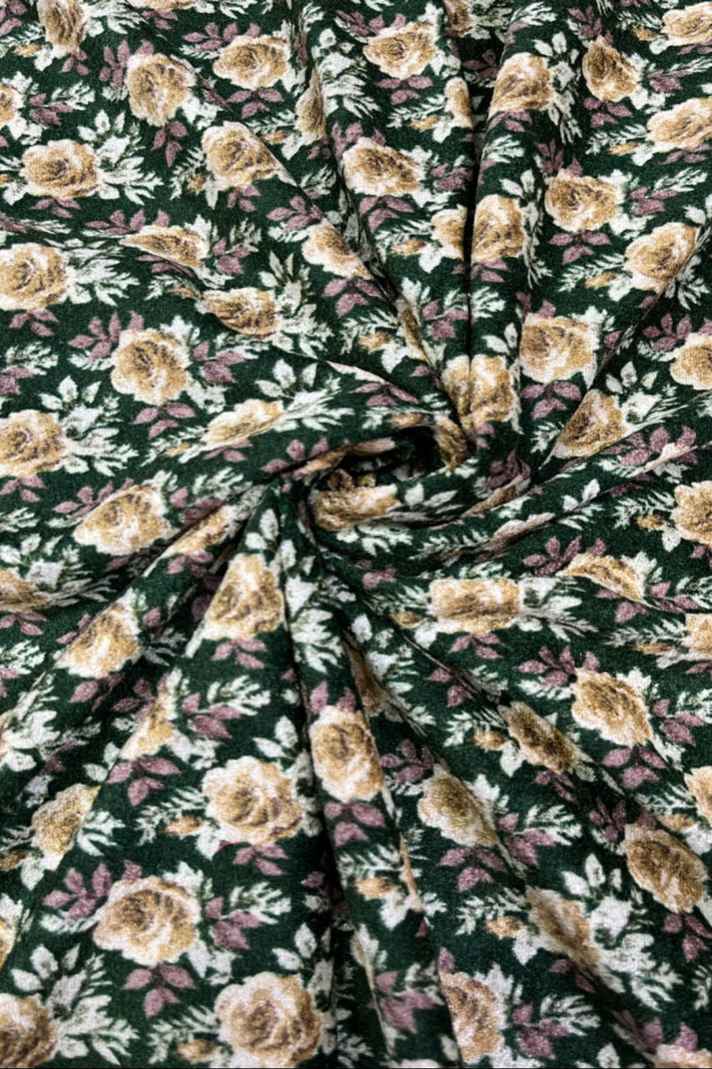 Floral fabric pattern with beige flowers on a green background