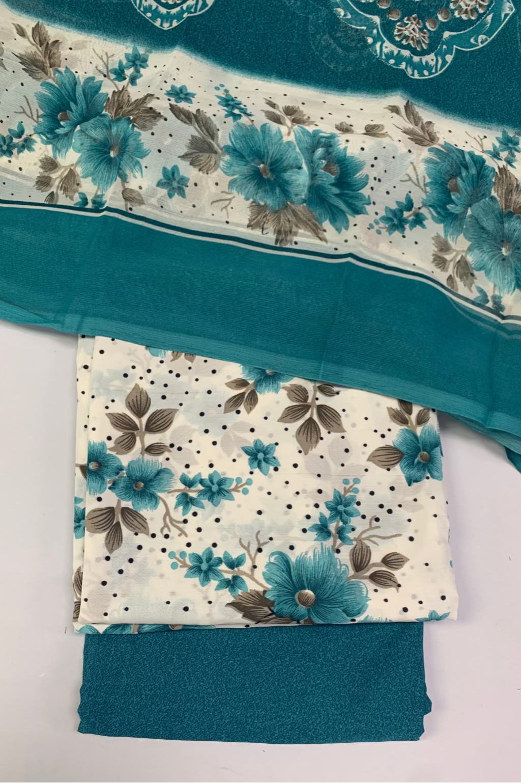 Teal fabric with floral pattern on a white background
