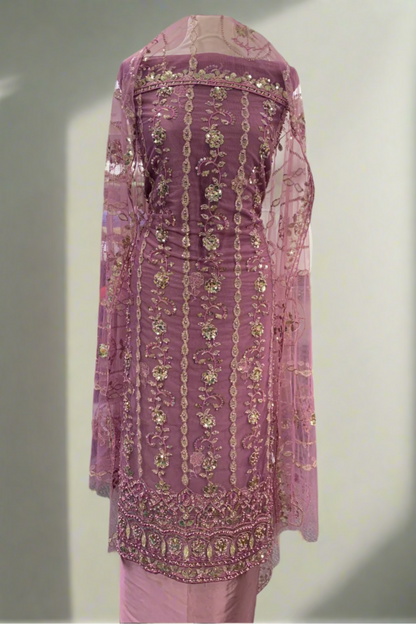 Pink embroidered traditional outfit in a store setting